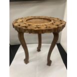 AN ASIAN STYLE SMALL WOODEN TABLE WITH CARVED DECORATION HEIGHT 32CM