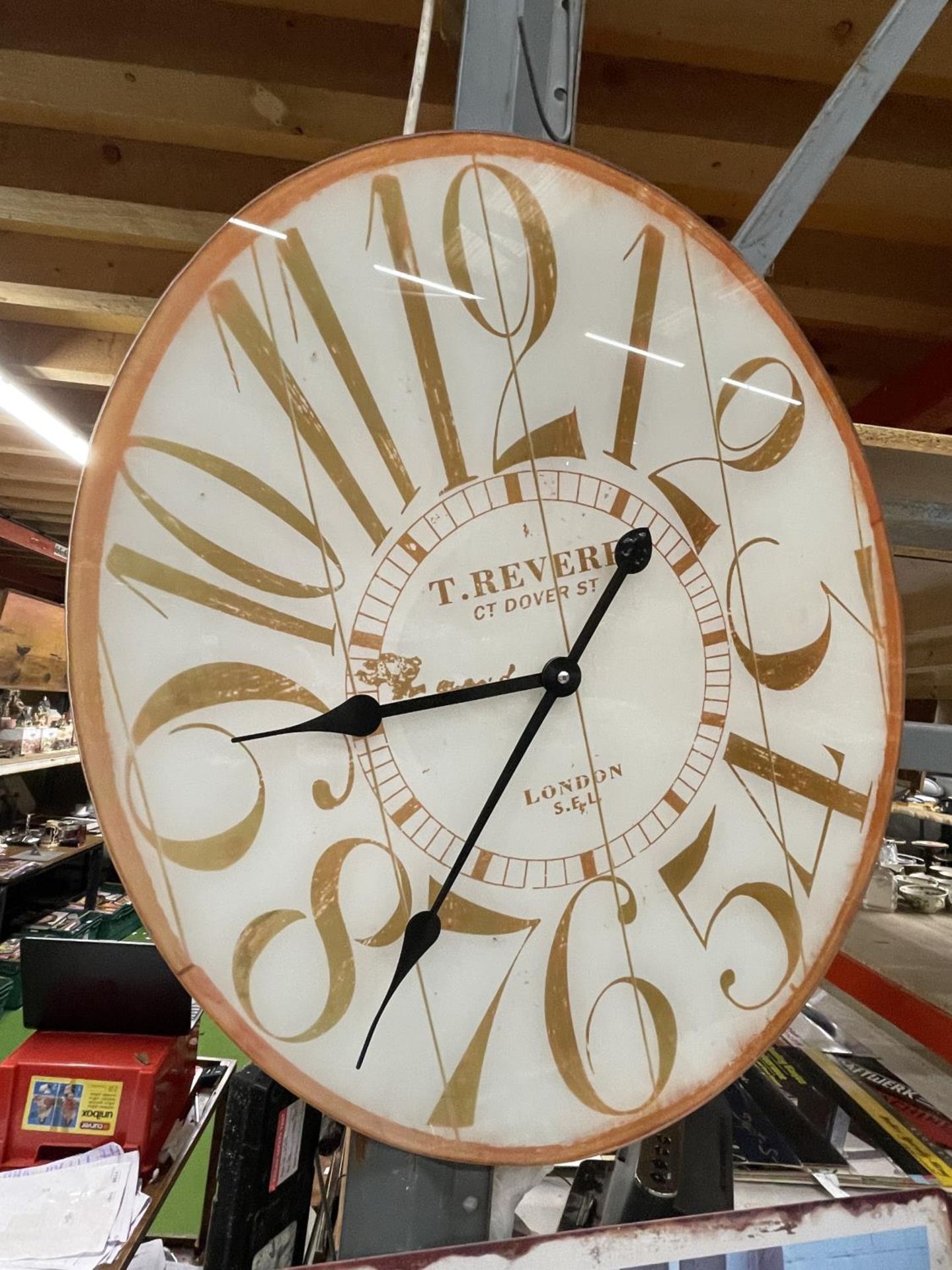 A LARGE OVAL WALL CLOCK 60CM X 50CM