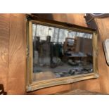 A LARGE DECORATIVE GILT FRAMED BEVELED EDGE WALL MIRROR