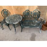 A VINTAGE CAST ALLOY BISTRO SET COMPRISING OF A ROUND TABLE, A BENCH AND A SINGLE CHAIR