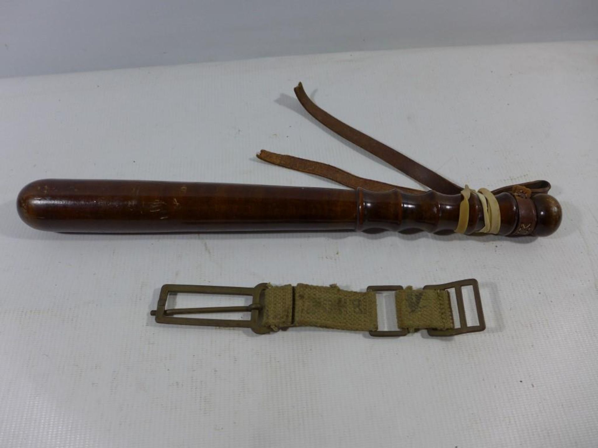 A WOODEN TRUNCHEON, LENGTH 40CM AND A CANVAS STRAP (2)