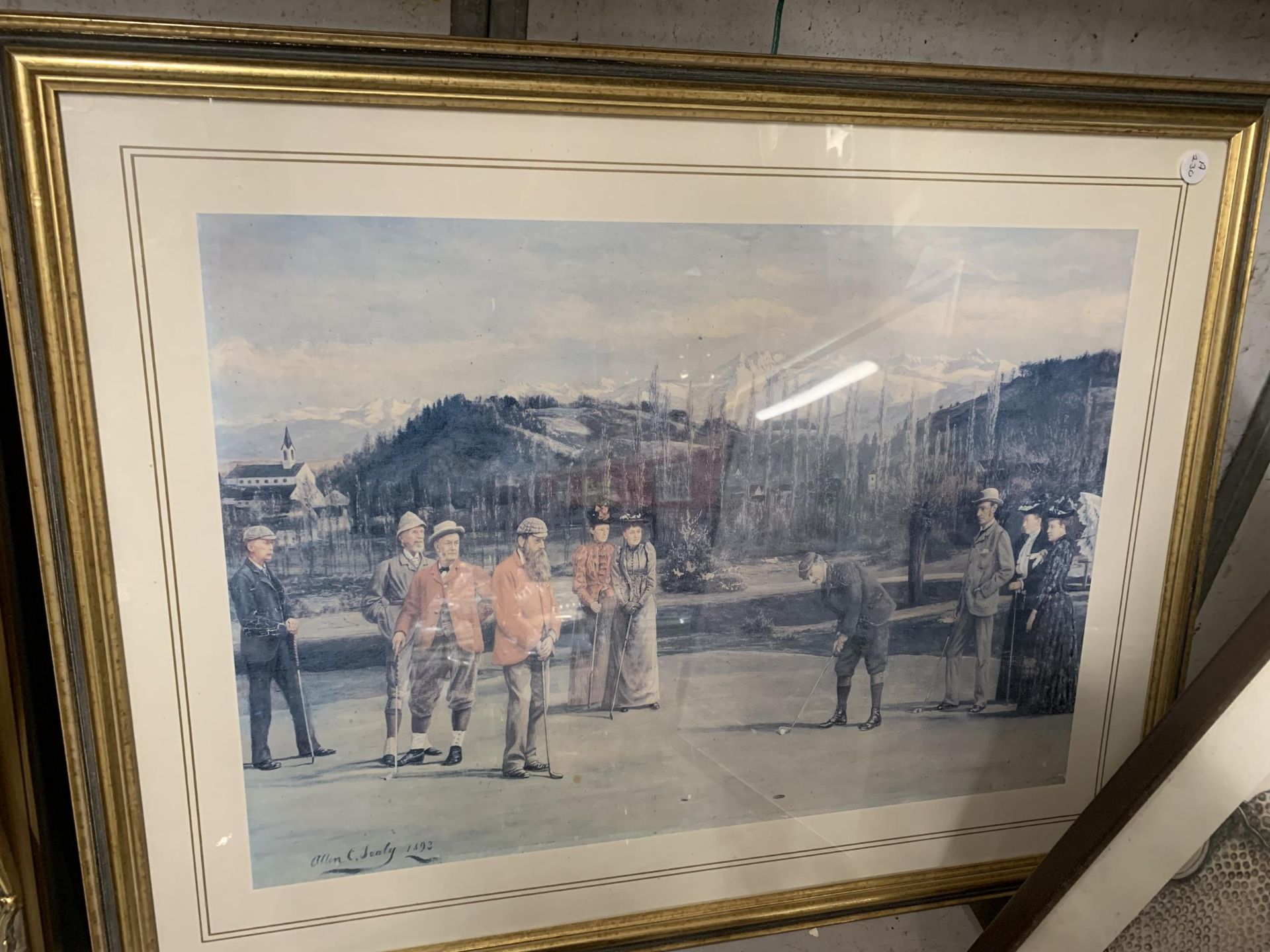 A FRAMED PRINT OF GOLFERS ON A PUTTING GREEN