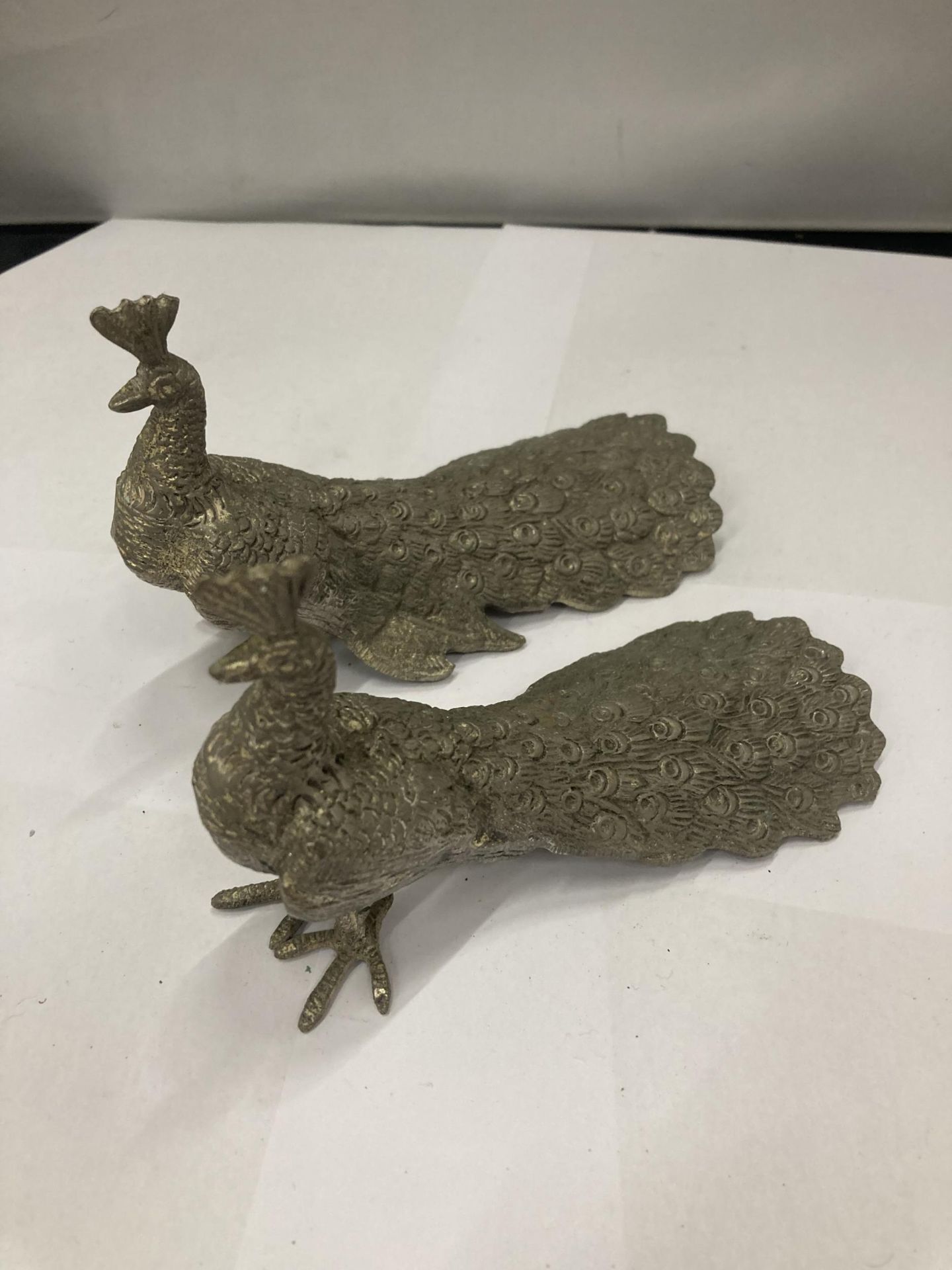 A PAIR OF WHITE METAL PEACOCKS - 1 A/F MISSING FOOT