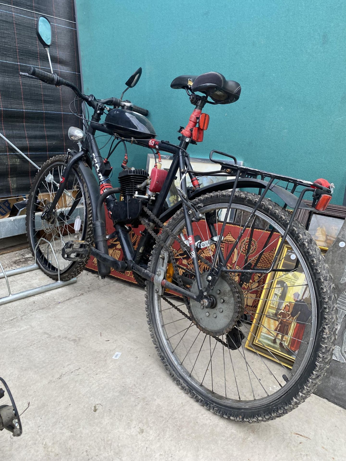 A ROCKRIDER PUSH BIKE WITH MOTORISED ENGINE