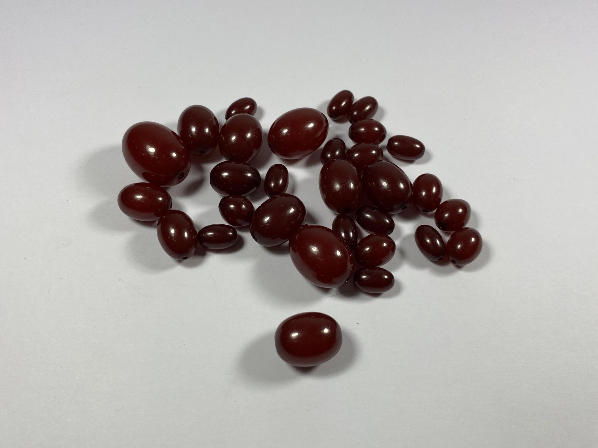 A COLLECTION OF LOOSE CHERRY AMBER BEADS