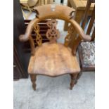 A VICTORIAN ELM AND OAK ELBOW CHAIR WITH SWEPT ARMS AND PIERCED SPLAT BACK