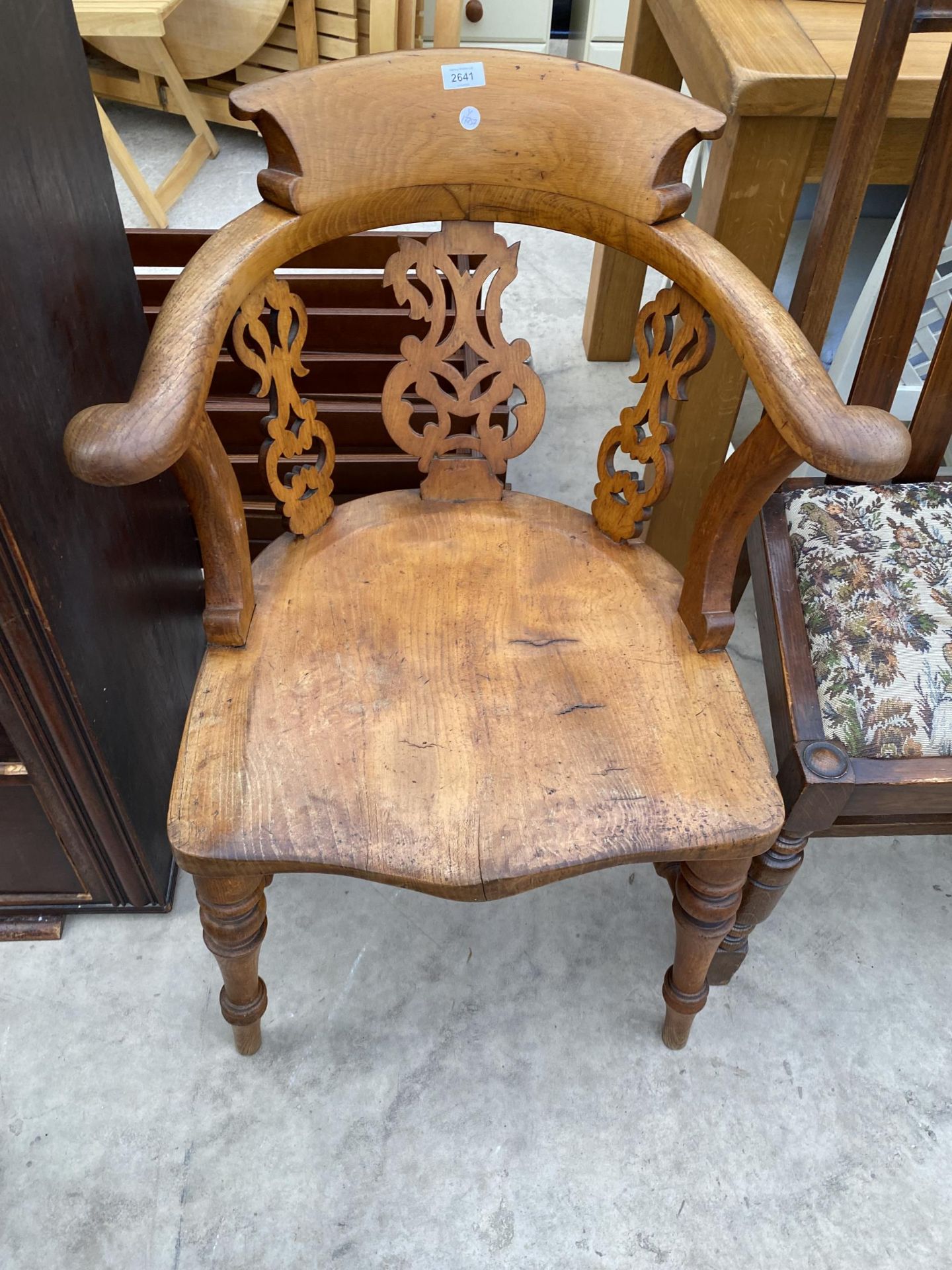 A VICTORIAN ELM AND OAK ELBOW CHAIR WITH SWEPT ARMS AND PIERCED SPLAT BACK