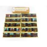 A BOX OF TEN COLOURED GLASS SLIDES RELATING TO THE TRANSVAAL WAR