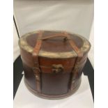 A ROUND LEATHER AND BRASS BOX - POSSIBLY A HAT BOX