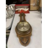 AN OAK FRAMED CARVED BAROMETER PLUS A BOXED BRONZE SERVING SET