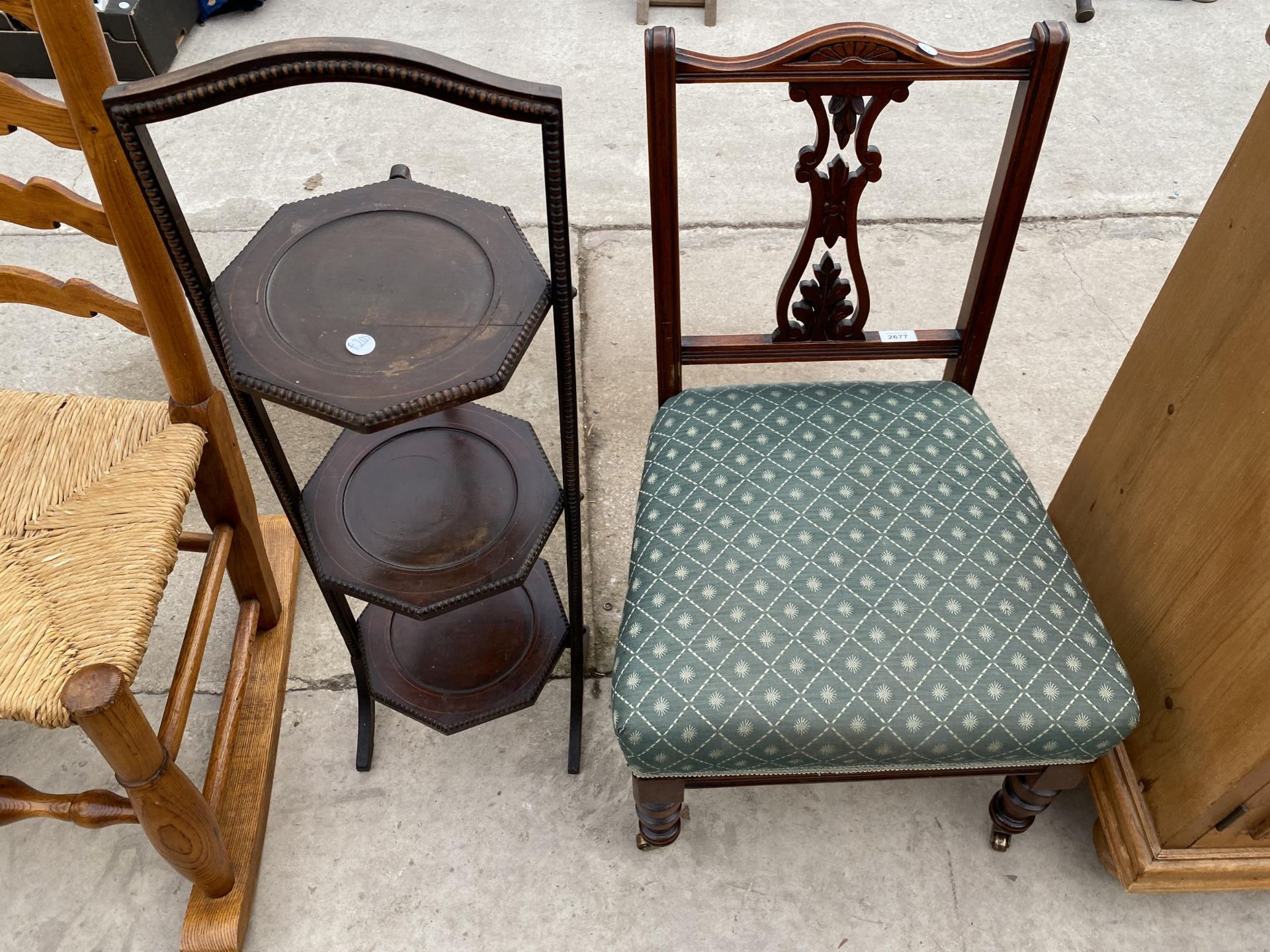 A LATE VICTORIAN NURSING CHAIR AND EARLY 20TH CENTURY MAHOGANY AND INLAID AFTERNOON TEA STAND