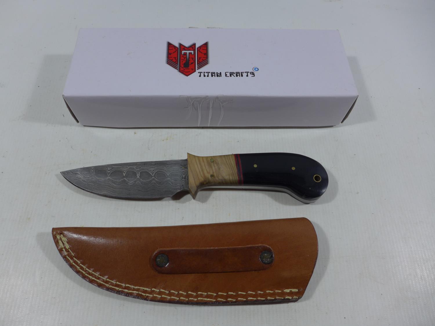 A BOXED TITAN CRAFTS KNIFE AND SCABBARD, 11CM DAMASCUS BLADE