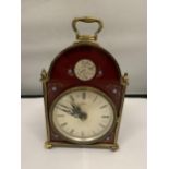 A 'BENTIMA' BRASS MANTLE CLOCK WITH A BURGUNDY AND FLORAL DECORATED FRONT HEIGHT 18CM