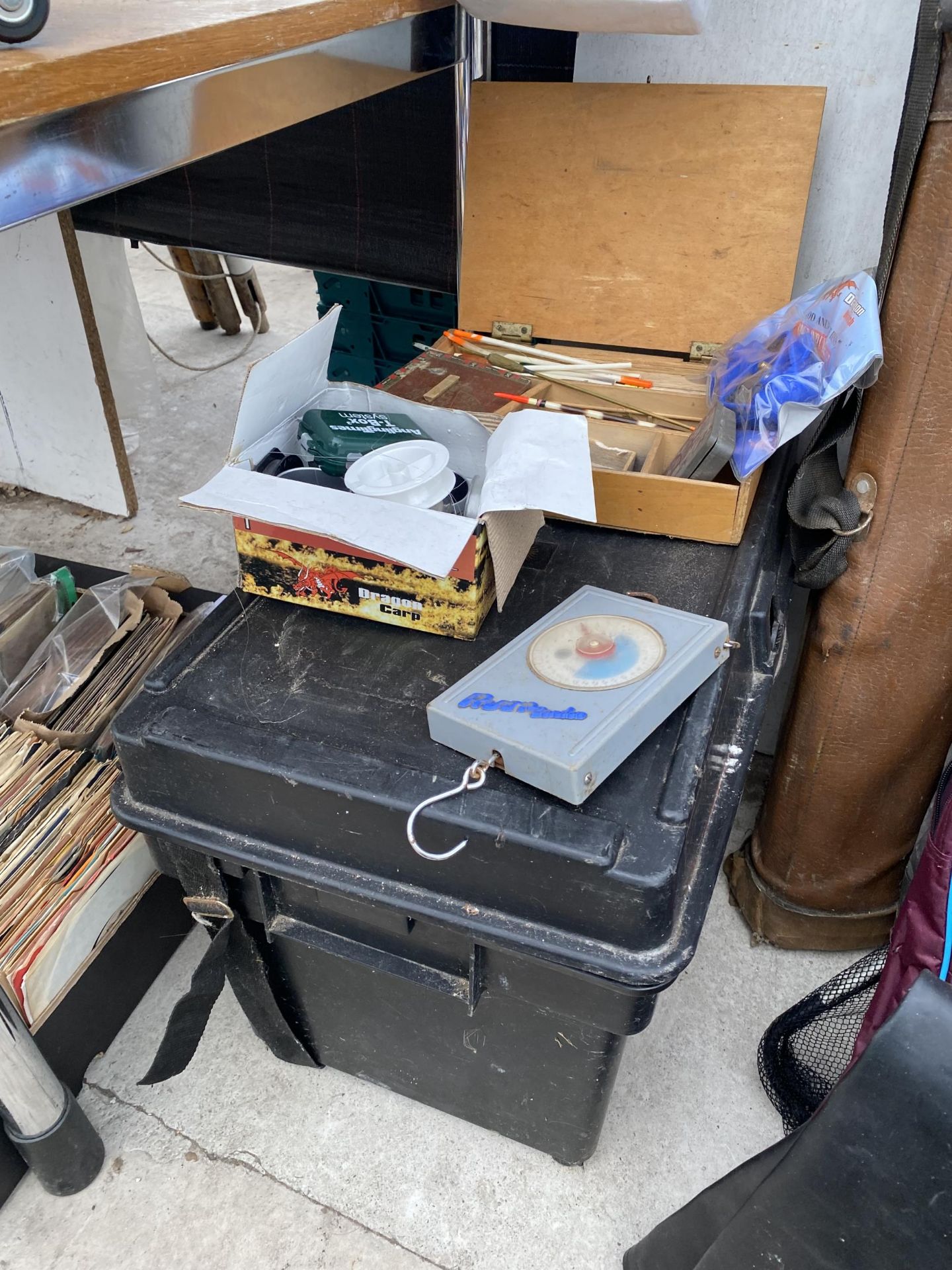 A FISHING TACKLE BOX CONTAINING A LARGE ASSORTMENT OF FISHING TACKLE TO INCLUDE FLOATS AND REELS ETC