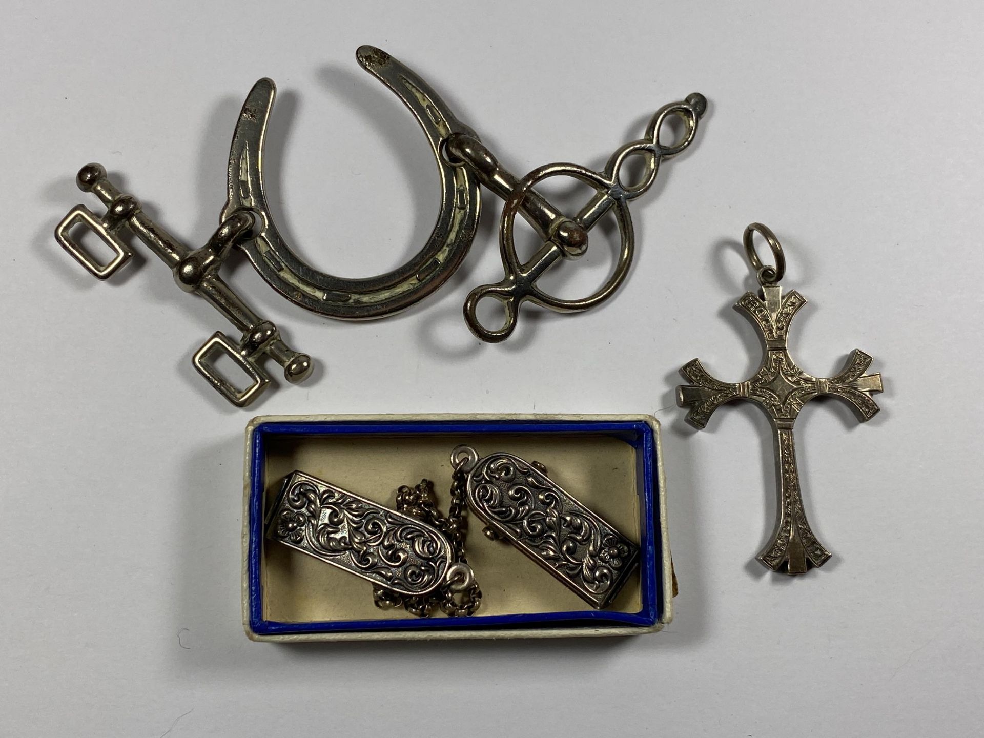 THREE ITEMS - HORSE SHOE BUCKLE, DUTCH WHITE METAL CLIPS AND WHITE METAL CROSS