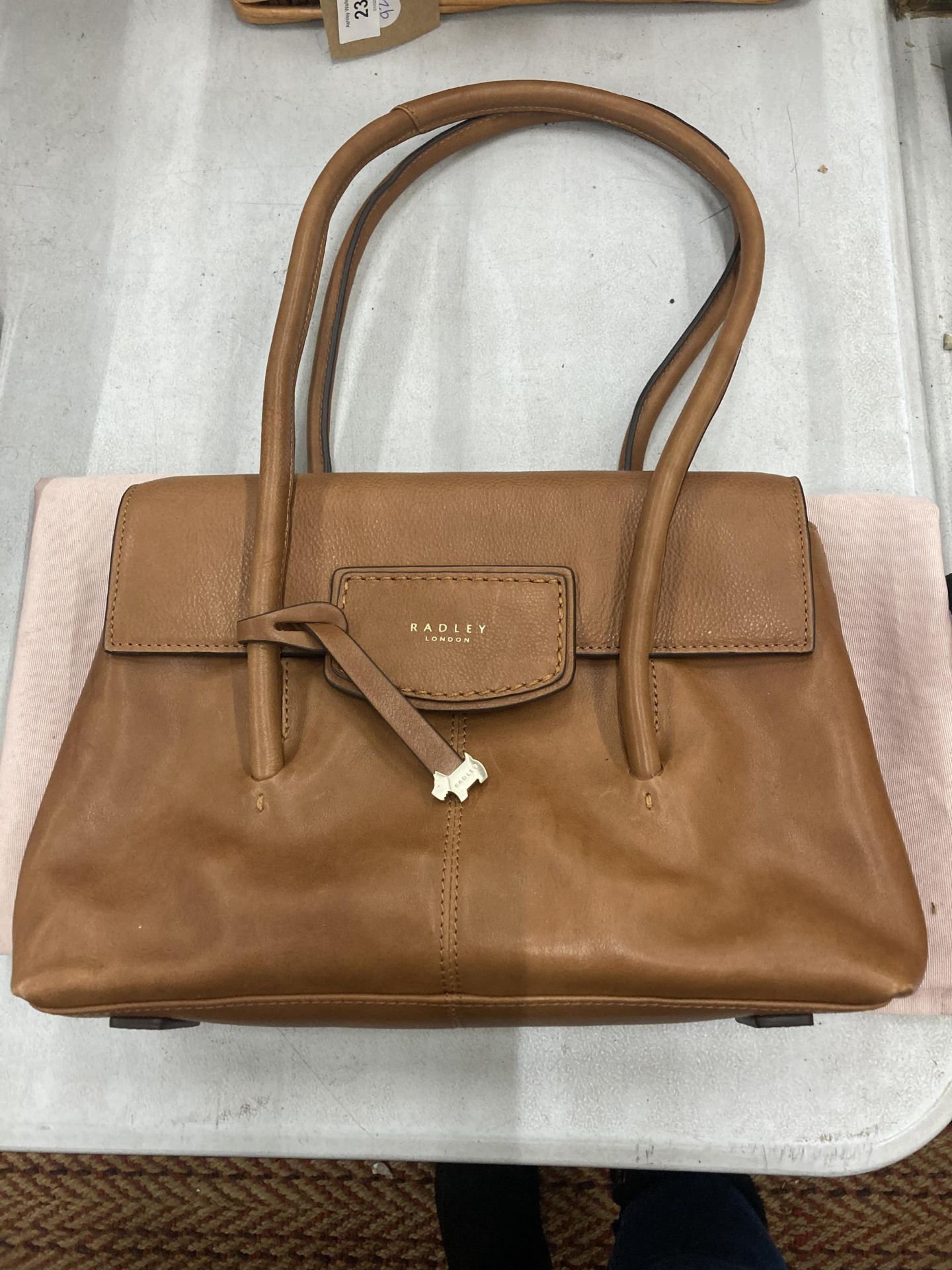 A VINTAGE TAN COLOURED RADLEY BAG WITH COVER