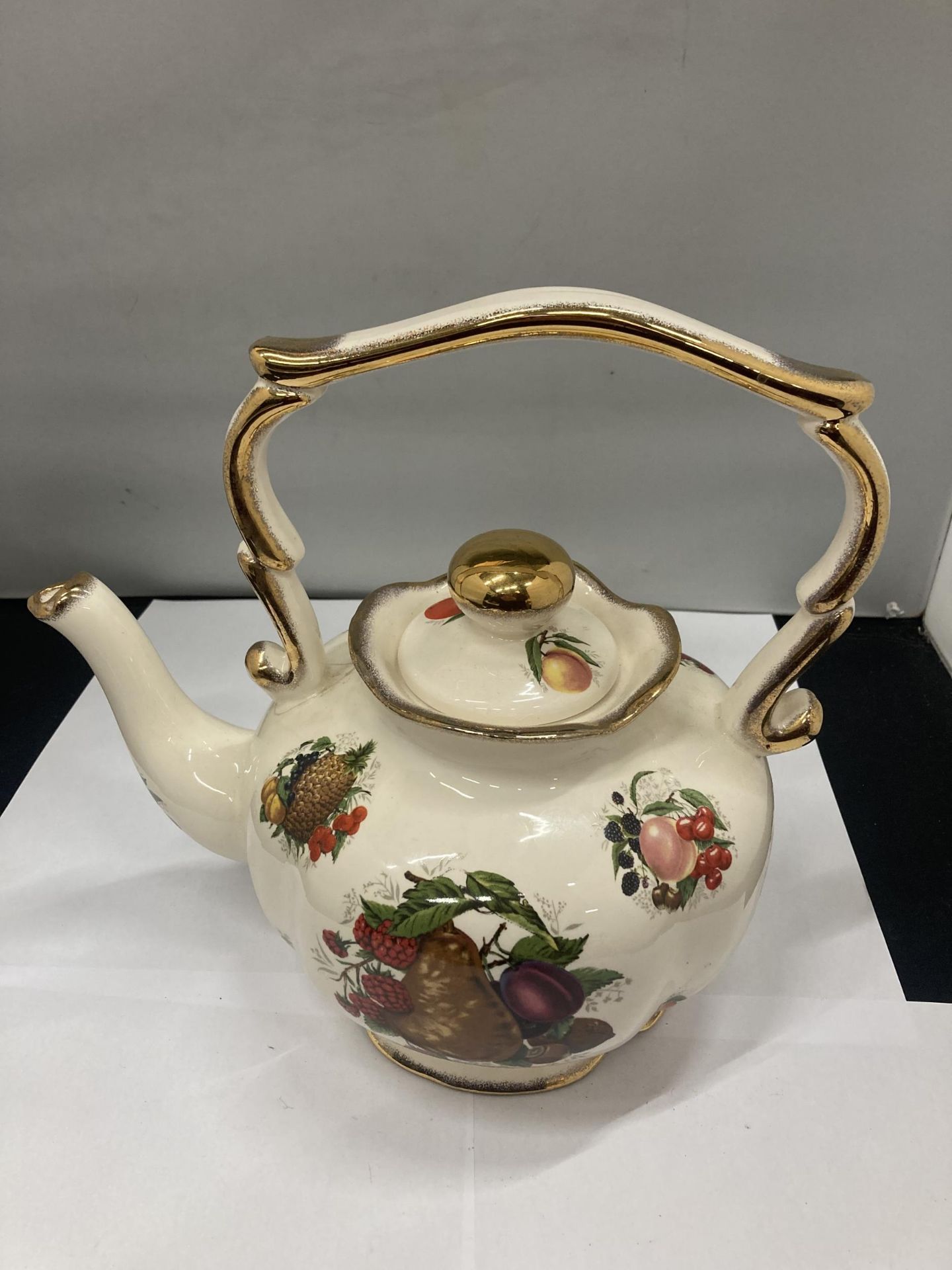 A POTTERY LARGE 'GYPSY' STYLE KETTLE WITH FRUIT DECORATION