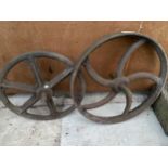 A PAIR OF VINTAGE CAST IRON PULLEY WHEELS