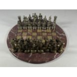 A METAL WARRIOR CHESS SET ON MARBLE BASE, BOARD DIAMETER 26CM