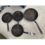 FOUR VINTAGE CAST METAL FRYING PANS