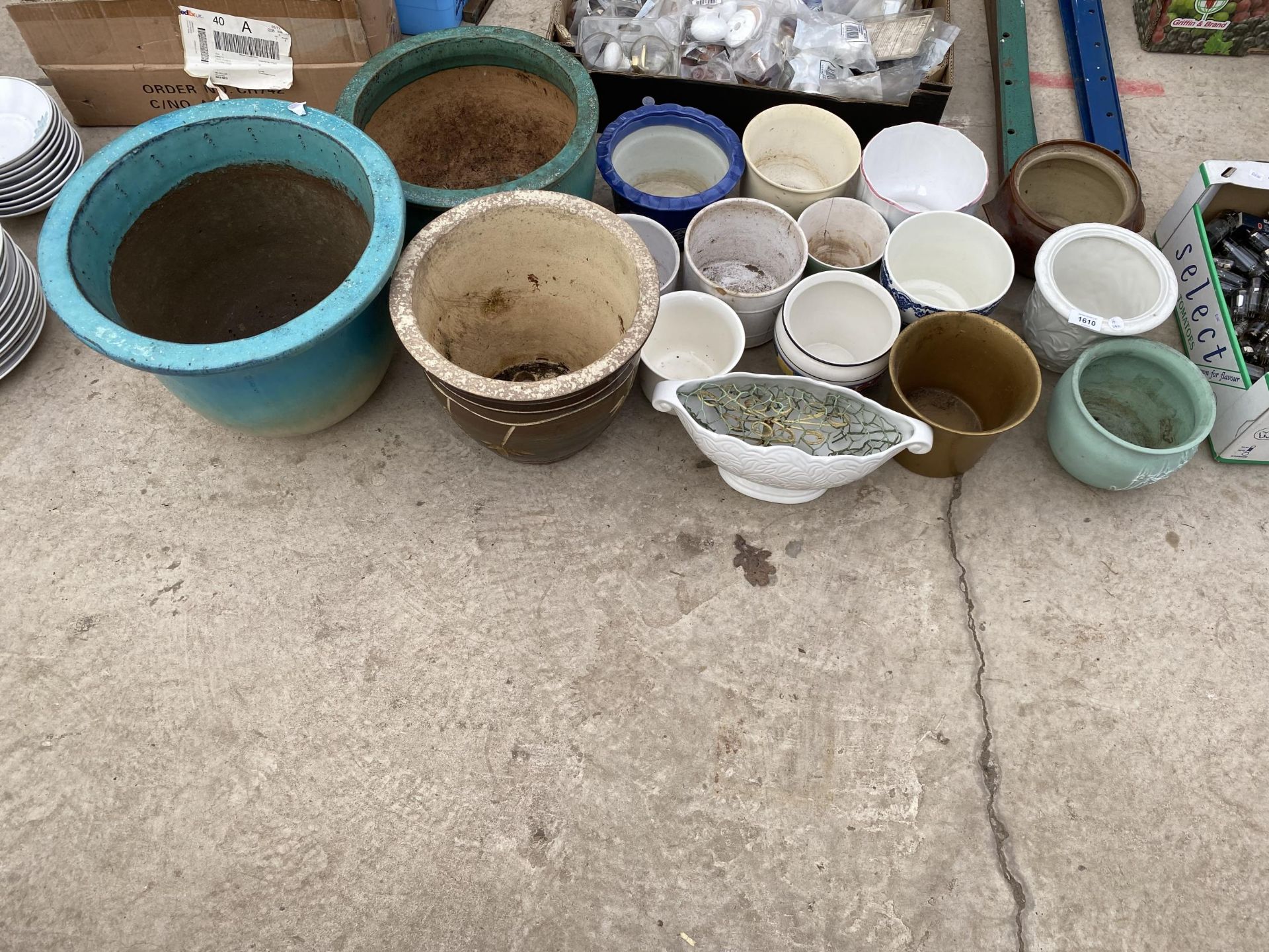 A LARGE ASSORTMENT OF GLAZED AND CERAMIC PLANTERS AND POTS
