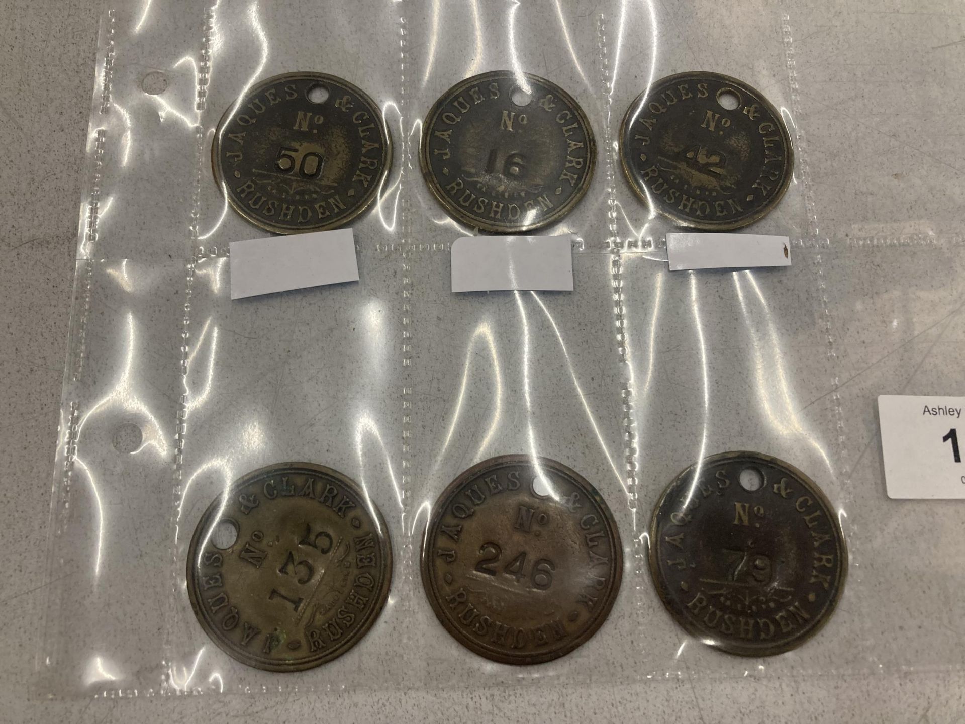 A QUANTITY OF VINTAGE 'JAQUES AND CLARK' CLOCKING IN TOKENS - 6 IN TOTAL