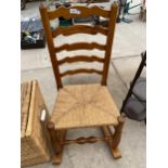 A 19TH CENTURY STYLE ELM ROCKING CHAIR WITH LADDERBACK AND RUSH SEAT