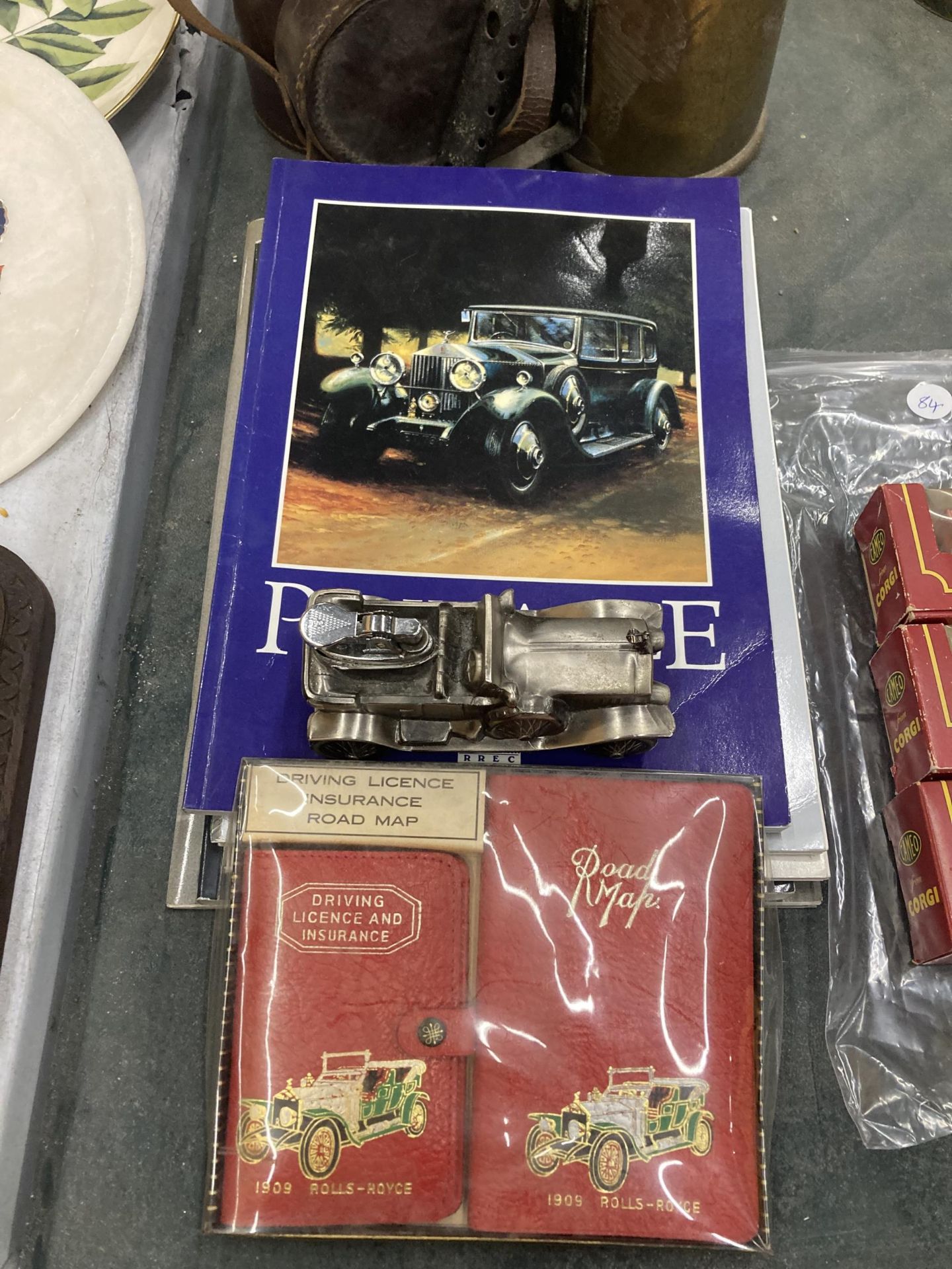 A ROLLS ROYCE MODEL TABLE LIGHTER, MAP, DRIVING LICENCE AND FIVE OFFICIAL ROLLS ROYCE BOOKS