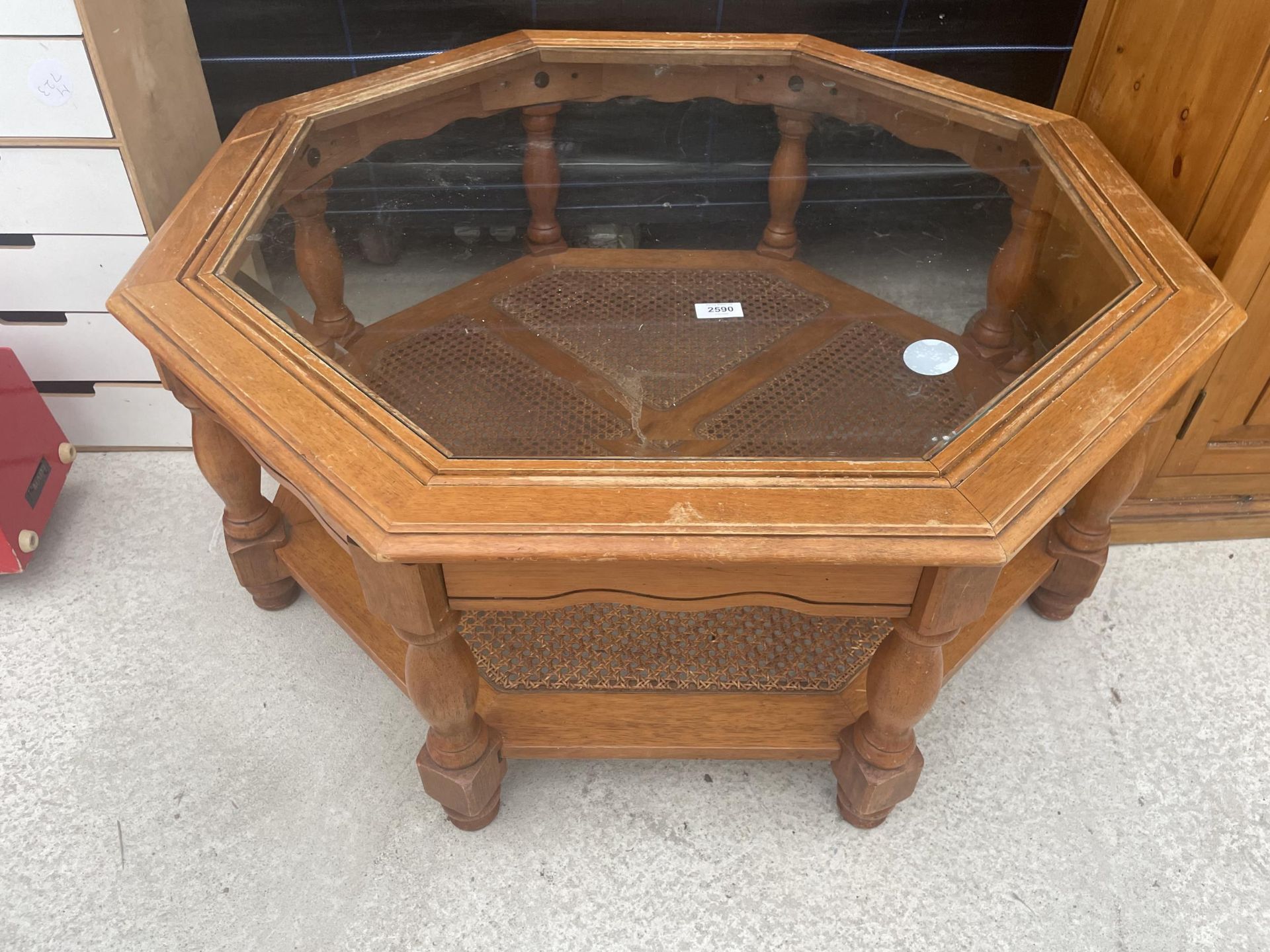 A MODERN OCTAGANOL TWO TIER COFFEE TABLE WITH INSET GLASS TOP AND CANE UNDER TIER 40" ACROSS