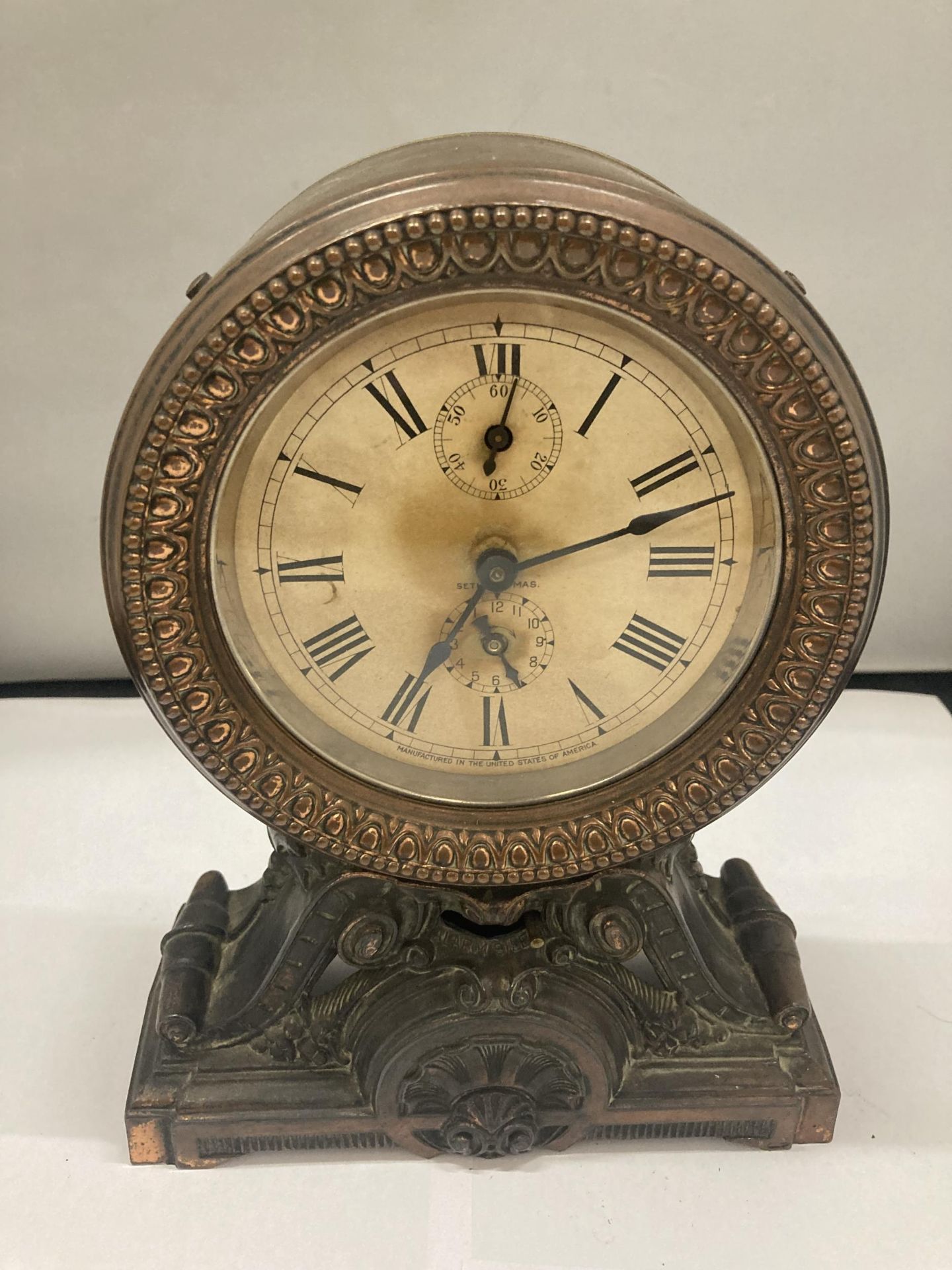 A VINTAGE METAL MANTLE CLOCK WITH ALARM