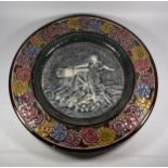 A LARGE MAJOLICA STYLE FRENCH POTTERY CHARGER DEPICTING A LADY WITH CANNON, DIAMETER 43CM