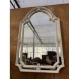 A DECORATIVE WHITE FRAMED WALL MIRROR