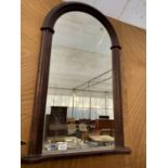 A WOODEN FRAMED CURVED TOP WALL MIRROR