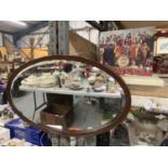 A MAHOGANY FRAMED OVAL MIRROR