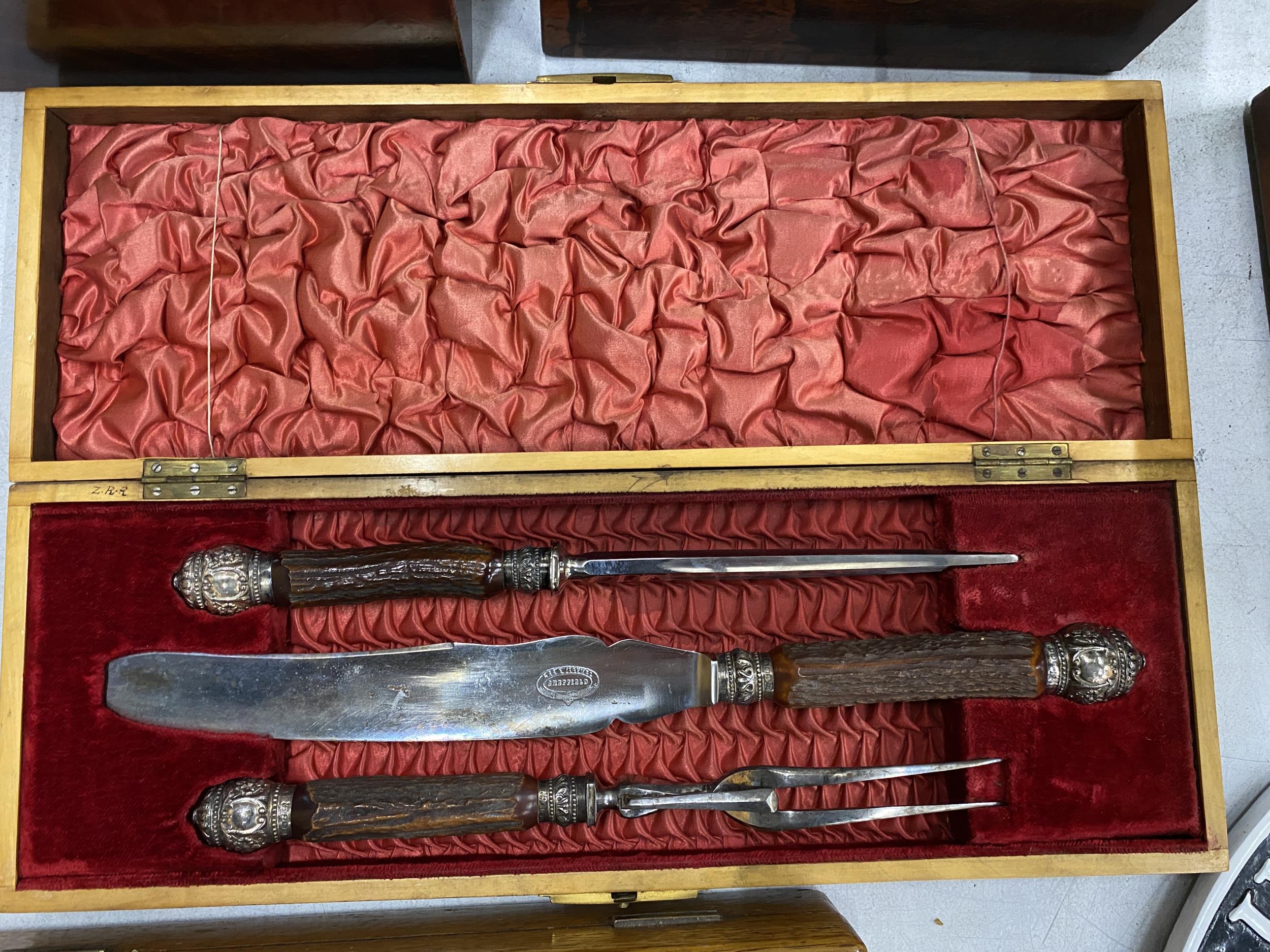 A VINTAGE CASED CARVING SET WITH HALLMARKED SILVER FERRULES