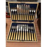 AN OAK CASED CANTEEN OF FISH CUTLERY WITH HALLMARKED SILVER COLLARS