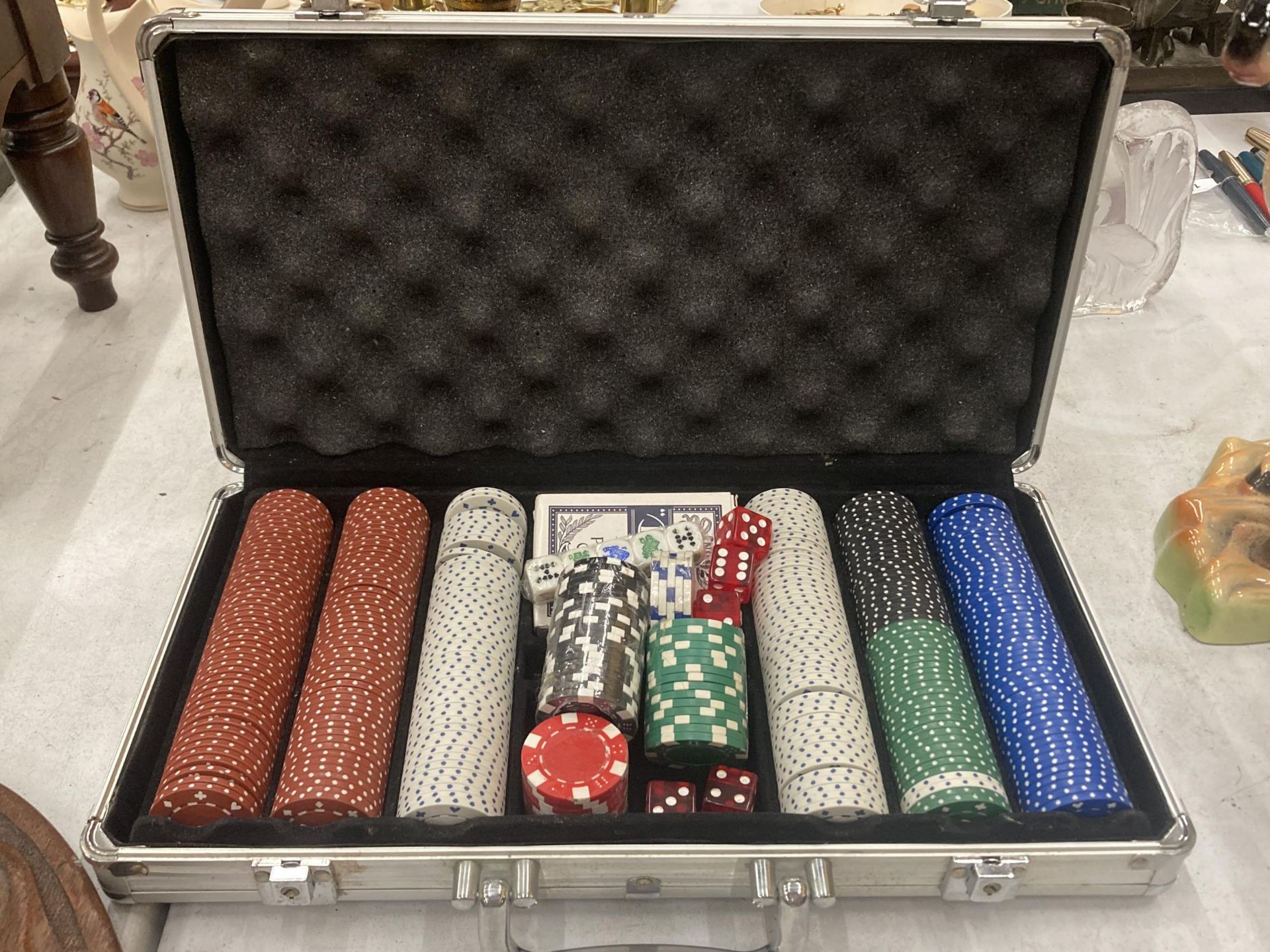 A POKER SET WITH POKER CHIPS, CARDS AND DICE IN AN ALUMINIUM CASE