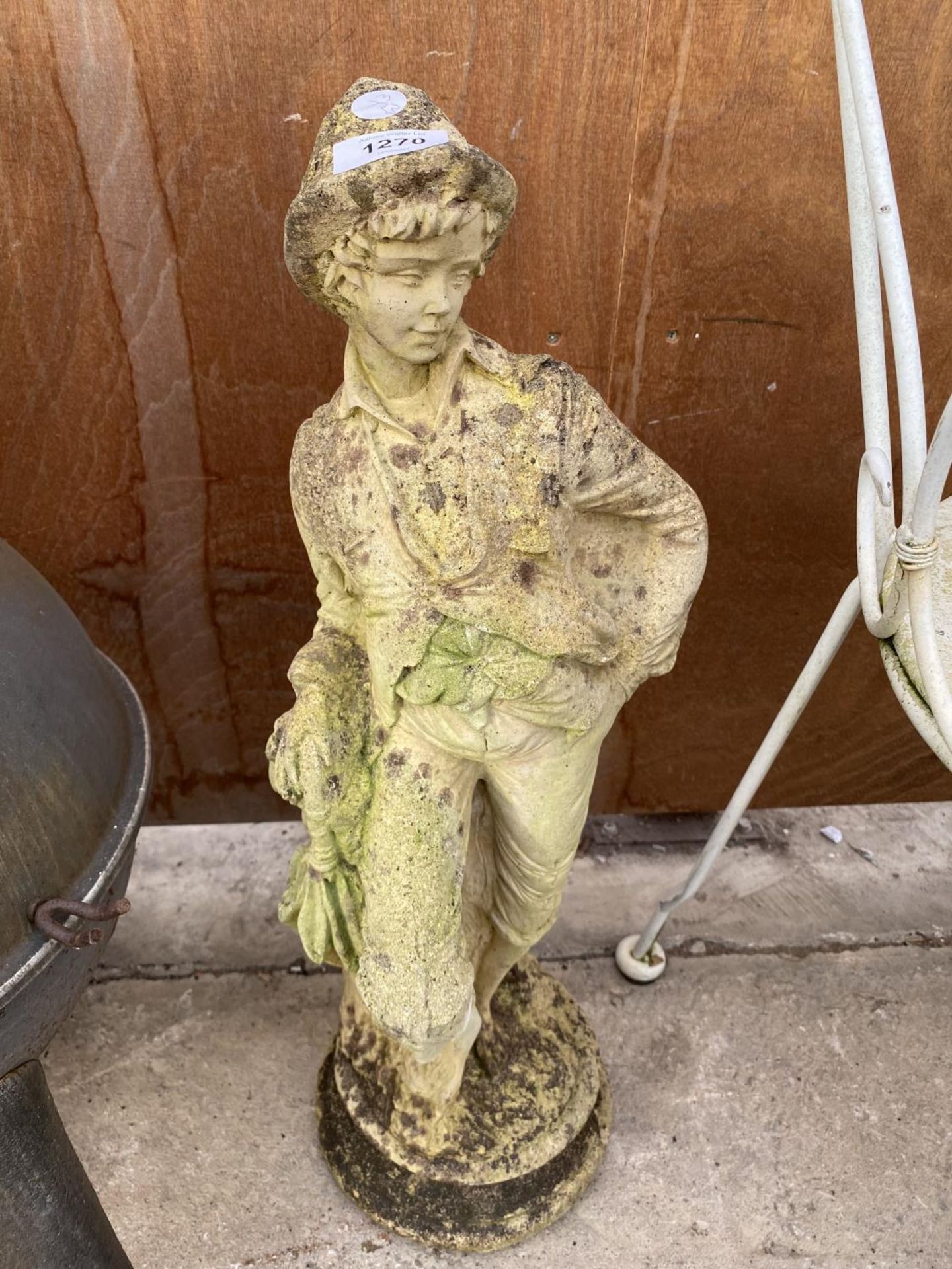 A RECONSTITUTED STONE FIGURE OF A YOUNG BOY