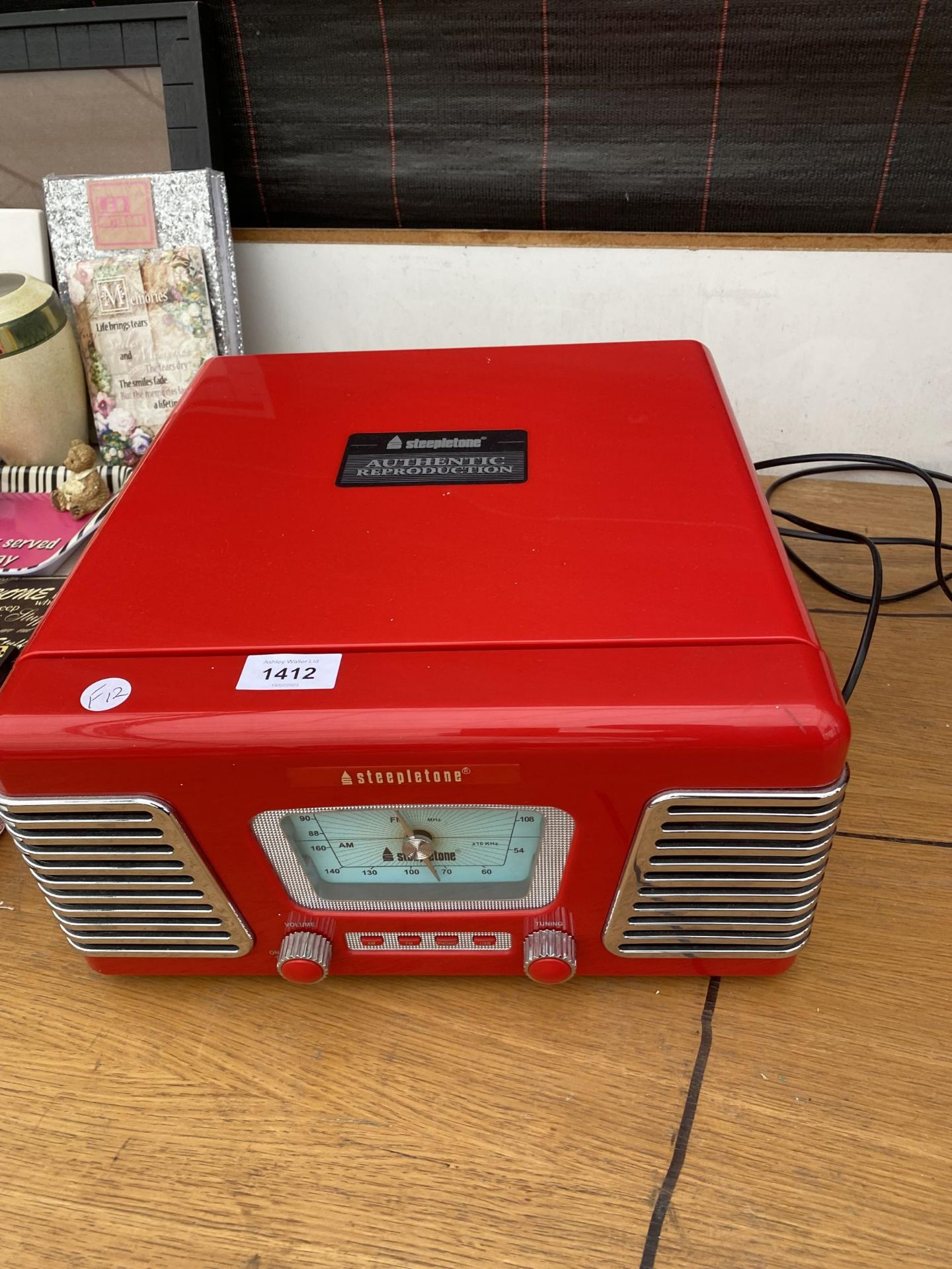 A STEEPLETONE RECORD PLAYER WITH BUILT IN SPEAKERS