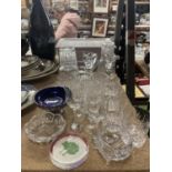 A QUANTITY OF GLASSWARE TO INCLUDE GLASSES, CANDLESTICKS, PAPERWEIGHT, TUMBLERWS