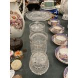 A GLASS FOOTED CAKE STAND, PLUS THREE STORAGE JARS
