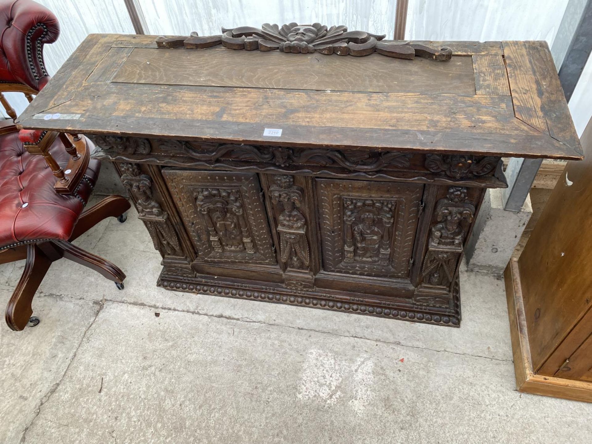 AN 18TH CENTURY HEAVILY CARVED TWO DOOR CABINET, 49" WIDE