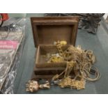 A QUANTITY OF YELLOW METAL COSTUME JEWELLERY TO INCLUDE CHAINS, EARRINGS, ETC IN A WOODEN BOX