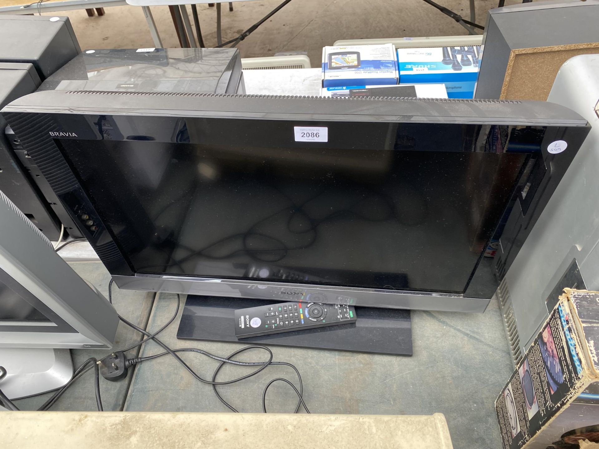 A SONY BRAVIA 26" TELEVISION WITH REMOTE CONTROL