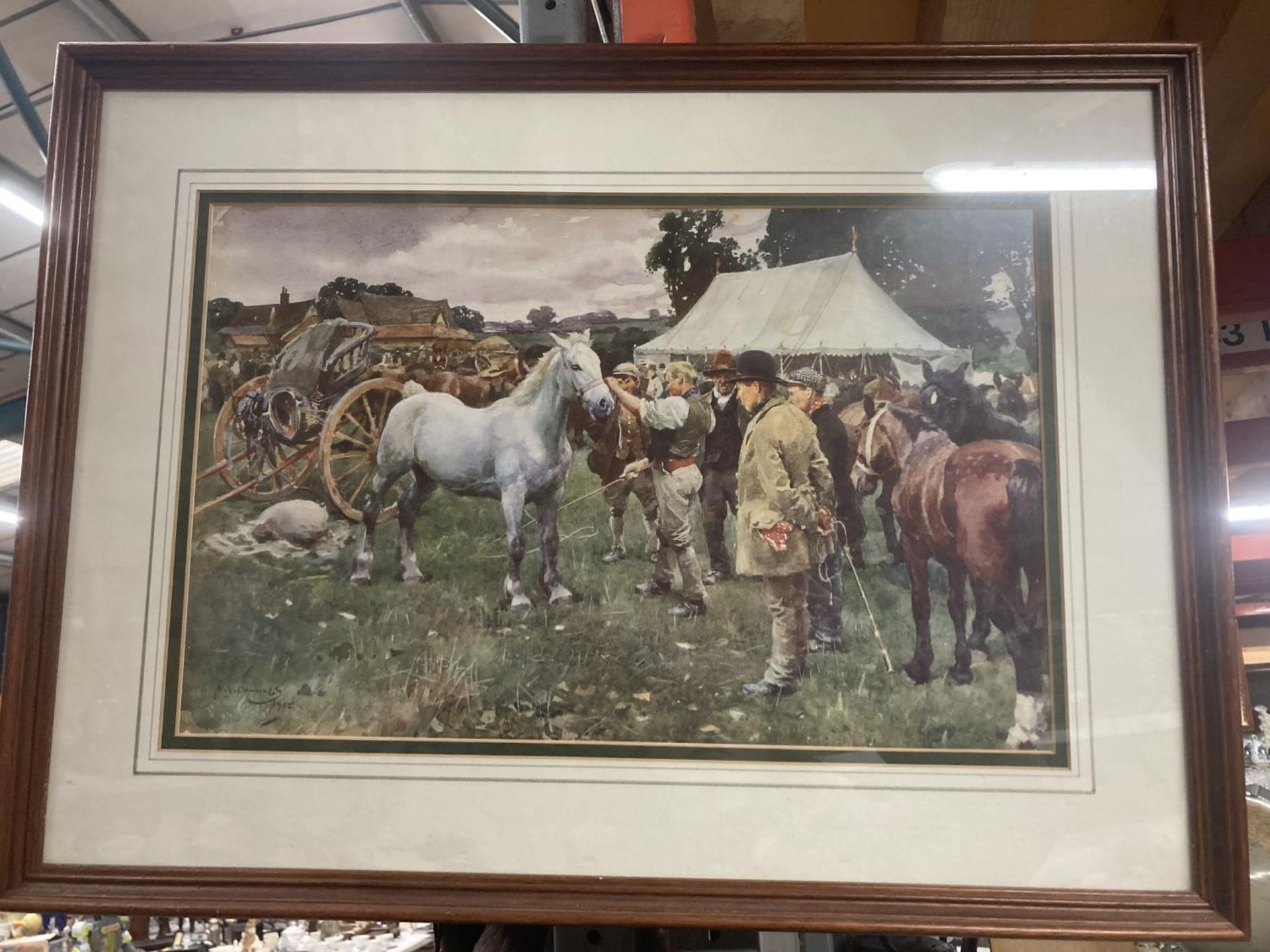 A FRAMED PRINT OF A HORSE FAIR