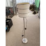 A METAL FLOOR LAMP WITH CREAM SHADE