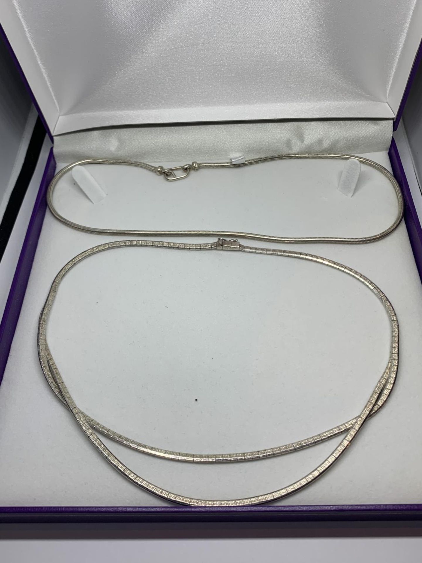 TWO SILVER NECKLACES WITH A PRESENTATION BOX