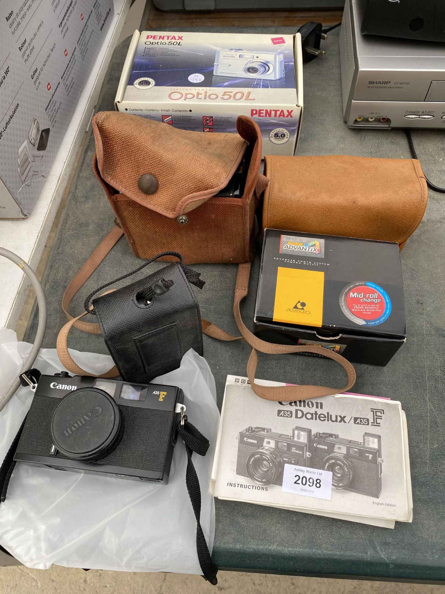 AN ASSORTMENT OF CAMERA EQUIPMENT TO INCLUDE A KODAK BROWNIE AND TWO CANON CAMERAS