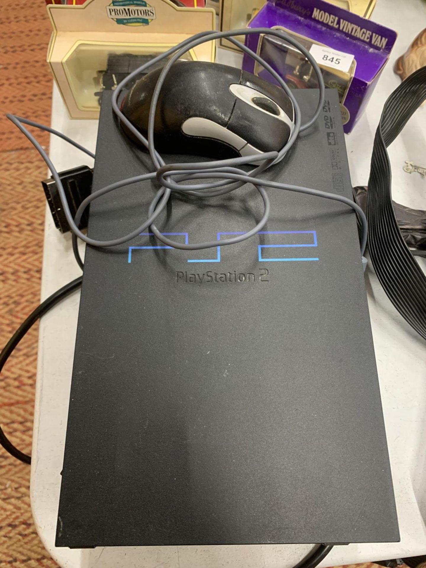 A SONY PLAYSTATION 2 WITH MICROSOFT MOUSE