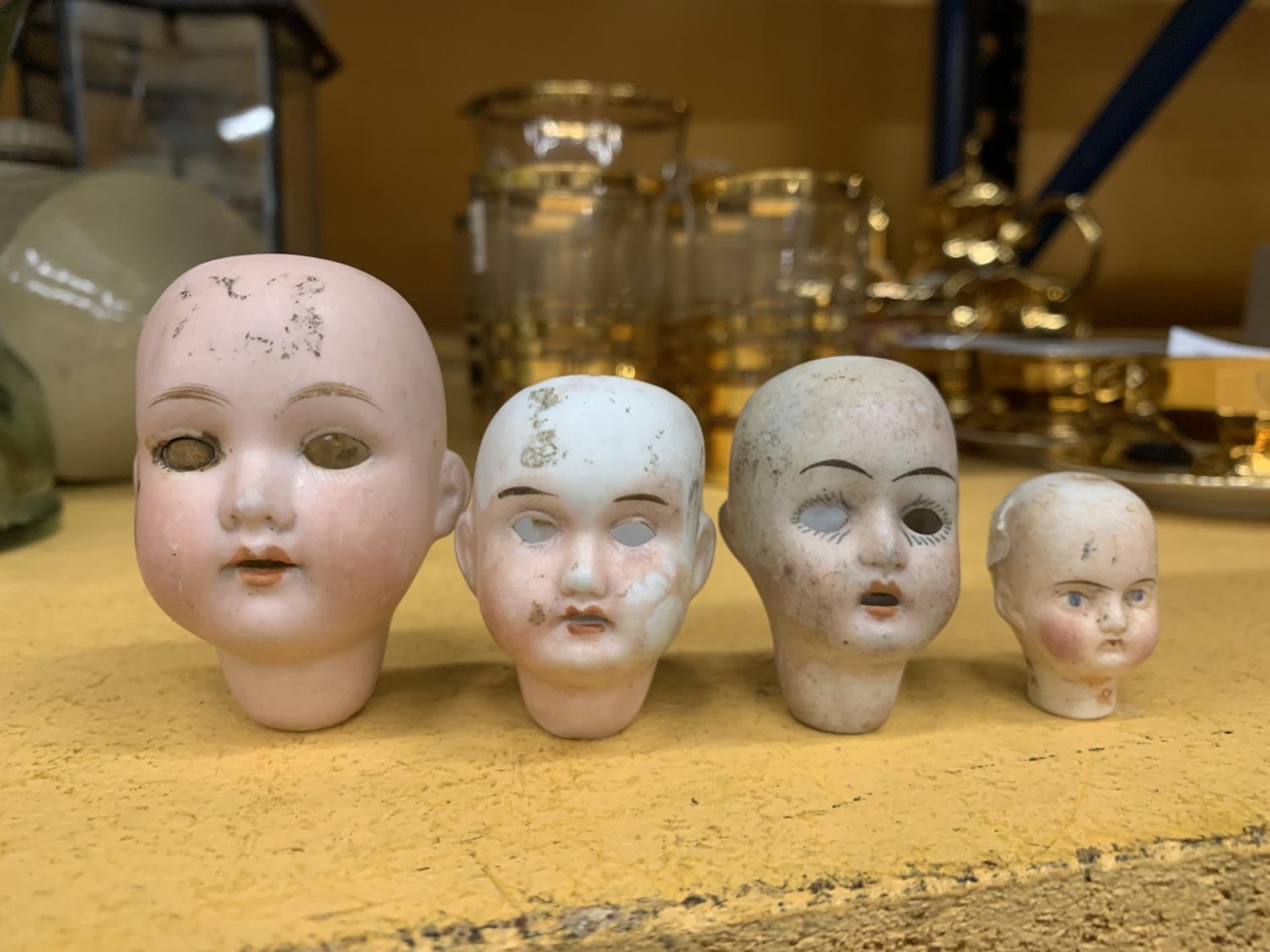 FOUR VINTAGE BISQUE DOLLS HEADS TO INCLUDE ONE MARKED GERMANY WITH THE NUMBER 395 A.100 M, A CEUS,